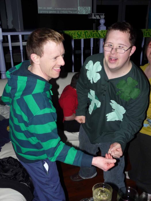 Two men in green dancing