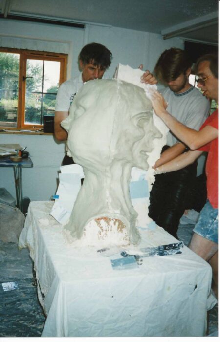 Three men with an unpainted double-sided head