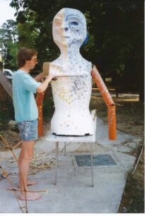 Man working on a Gigante torso with arms added