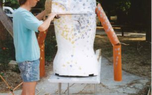 Man working on a Gigante torso with arms added
