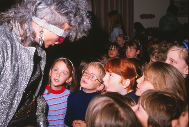 The alien tries to talk, copying the children
