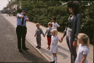 The children teach Zerena how to cross the road