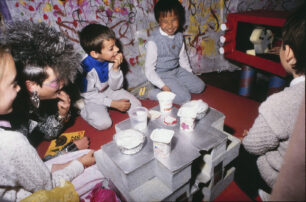 The children and Zerena watch TV in Zerena’s home