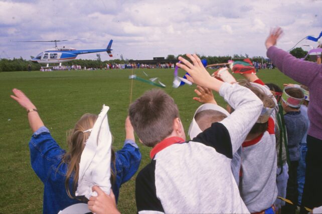 The children wave Zerena and the Professor goodbye as they climb into a helicopter