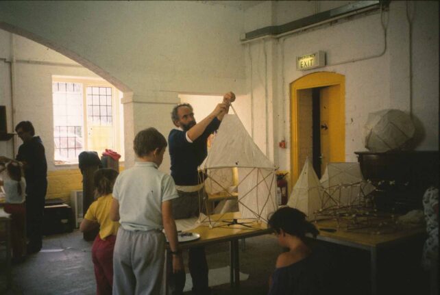 Man and children making bamboo frames