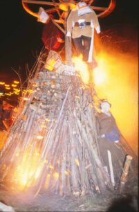 A bonfire with several effigies on