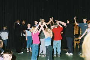 Children holding hands above their heads forming arches