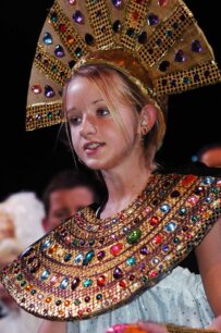Girl with bejewelled headdress and neckdress