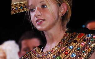 Girl with bejewelled headdress and neckdress