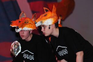 Two boys in fox heads and black SHED MK t-shirts
