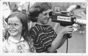 Two children with a Channel 40 video camera