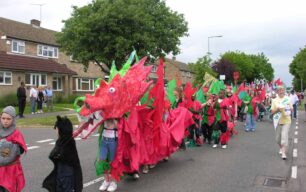 Red and green dragon parading