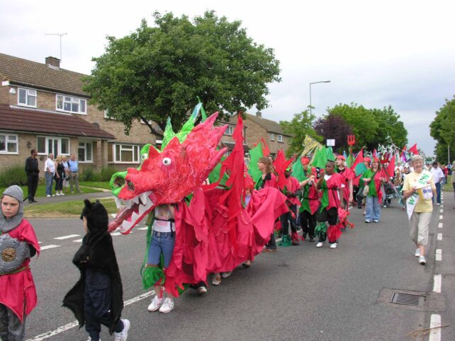 Red and green dragon parading