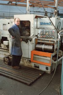 Pete Martin beside lathes in Fitting & Machine Shop