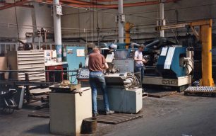 Two men at Middle Bay Auto lathes in Fitting Shop