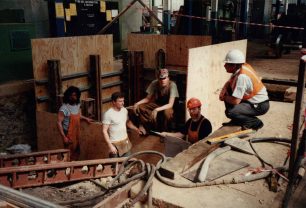 Five men at work below floor level
