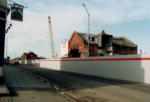 Stratford Road hoarding with Old Bath House & Works Fire Station behind
