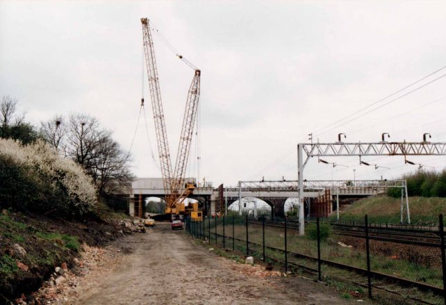 Large crane lifting centre spans into place for Blue Bridge new road bridge