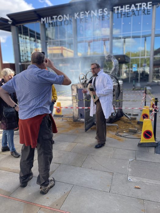 Man scratches his head at site of crash-landed spaceship