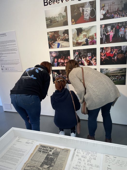 Ex- pupils look at exhibition photos featuring themselves in 1988