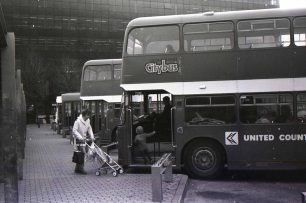 A woman and a child boarding a bus