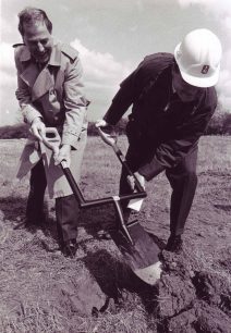 Two men cutting the first sod for Pharmacia