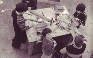 A group of five boys woodworking