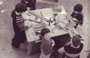 A group of five boys woodworking