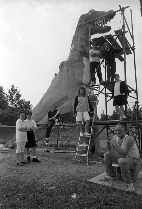 Bill Billings, creator of the dinosaur, with local children