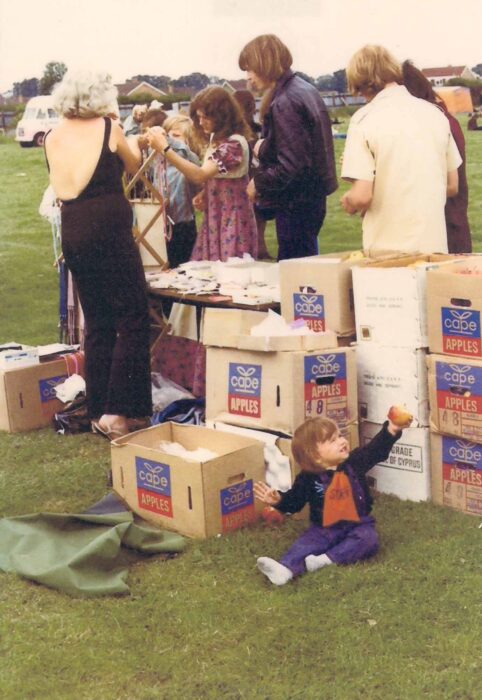 Group of people looking at items on stall