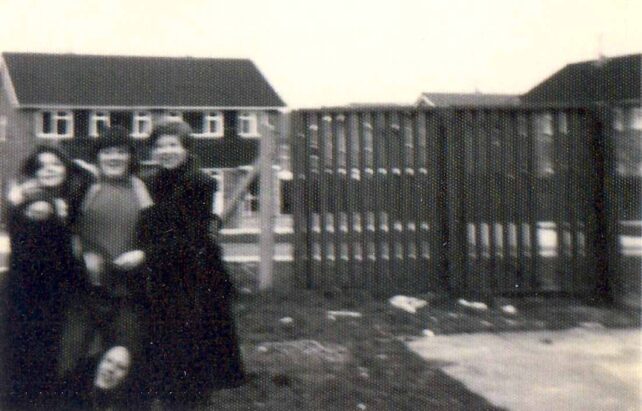Three girls posing for camera