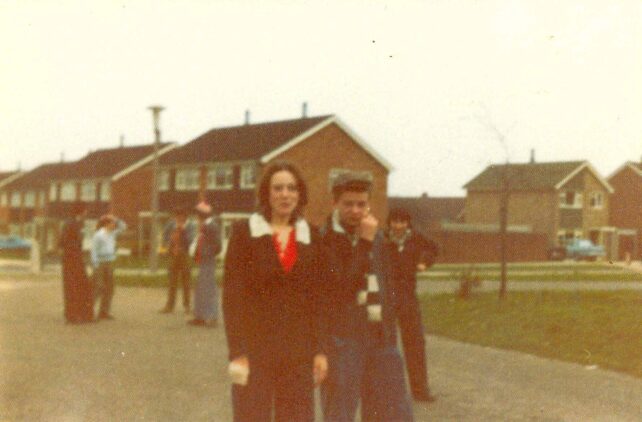 Young people with houses in background