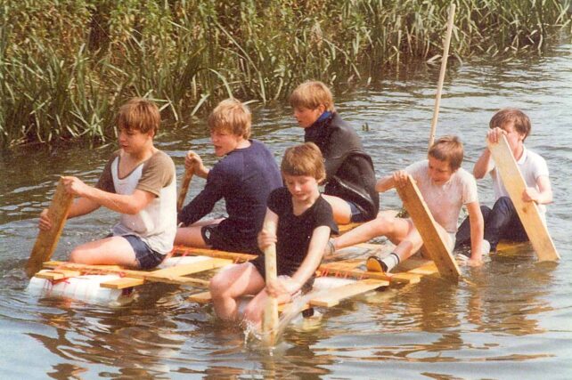Youths paddling their raft