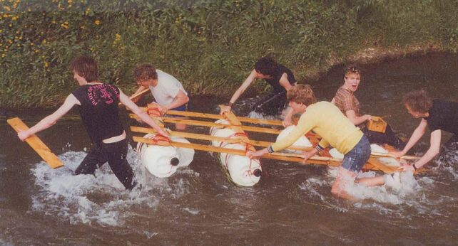 Youths dragging the raft along