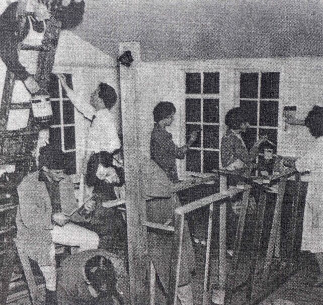 Group of youths decorating building