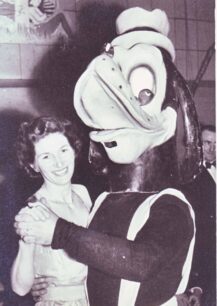 Lady dancing with costumed duck