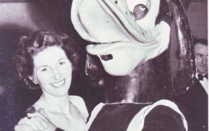 Lady dancing with costumed duck