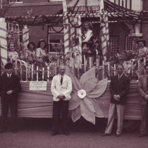 Carnival lorry with Alfred Cowlishaw in white jacket