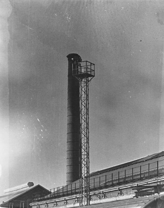 Chimney on powerhouse, Lighting gantry in foreground