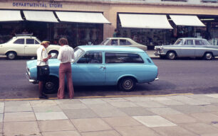 Traffic warden booking motorist outside Co-Op, circa 1970