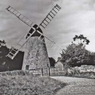 2 images of the windmill showing some repairs made by MKDC