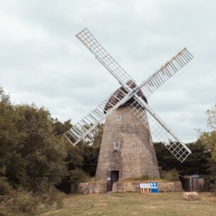 2 images of the windmill framed by trees