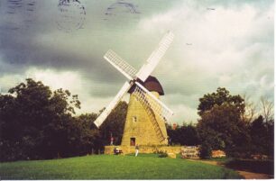 The picture side and obverse of a  franked postcard of the windmill 1982