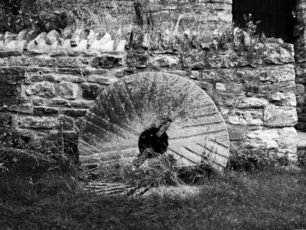 Broken bedstone against a stone wall