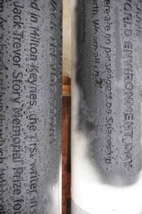 White pillars with black lettering