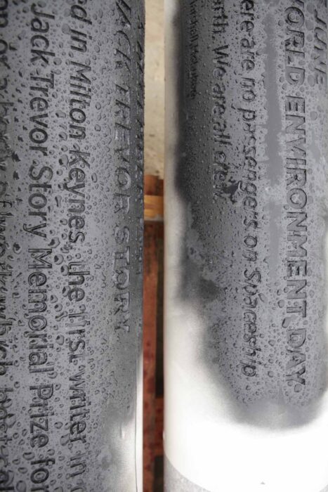White pillars with black lettering