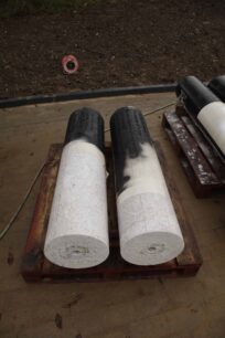 White pillars with black lettering