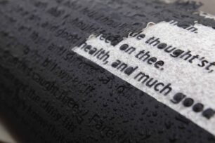 White pillars with black lettering