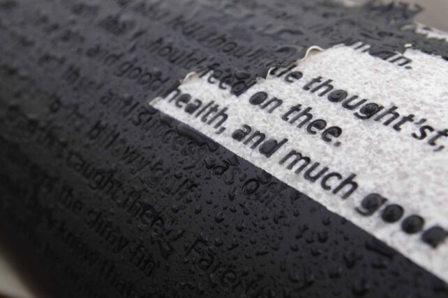 White pillars with black lettering